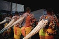 Hindu devotees pulling a float with ropes hooked on their backs at Thaipusam in Penang, Malaysia