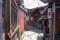 A wooden walkway through traditional stilt houses in the Clan jetties of a waterside