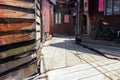 A wooden walkway through traditional stilt houses in the Clan jetties of a waterside