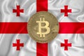 Georgia flag, bitcoin gold coin on flag background. The concept of blockchain, bitcoin, currency decentralization in the country.