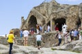 Crowds of tourists explore caves and ruins in Uplistsikhe, Georgia