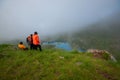 Georgia, Khevsureti - July 9, 2017: Three friends enjoy the beauty of a misty mountain lake