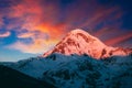 Georgia. Mount Kazbek Covered Snow In Winter Sunrise. Morning Dawn Colored Top Of Mountain In Pink-orange Colors Royalty Free Stock Photo