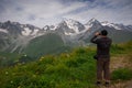 Georgia, Racha - August 16, 2013: The traveling man enjoys a magnificent view of the mountains