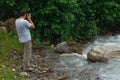 Georgia, Racha - July 9, 2013: A traveling man takes a photo of the river