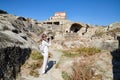 Georgia, Tbilisi - October 21, 2019: Attractive beautiful young girl who is female photographer traveller holding modern mirror