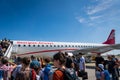 Georgian Airways Embraer aircraft and passengers boarding.