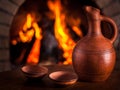 Georgian clay pottery against cozy fireplace background, winter
