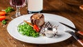 Georgian cuisine. Juicy beef steak, veal steak on a white plate with roasted rocket, grilled vegetables and sauce Royalty Free Stock Photo