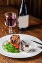 Georgian cuisine. Juicy beef steak, veal steak on a white plate with roasted rocket, grilled vegetables and sauce Royalty Free Stock Photo