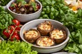Georgian cuisine. Stuffed shampignon mushrooms with suluguni cheese baked in ketsi pan with greens and vegetables Royalty Free Stock Photo