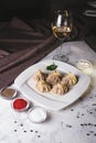 Georgian Hinkali on a white plate with sauce in the restaurant Royalty Free Stock Photo