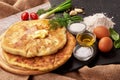 Georgian khachapuri with cheese and green herbs inside. On rustic background Royalty Free Stock Photo