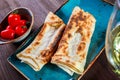 Georgian lavash, fresh pita bread on a plate on wooden background. Caucasian kitchen.