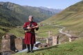 Georgian man plays local musical instrument of panduri and sings traditional svanetian songs in Ushguli, Caucasus Mountains, Georg