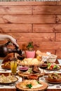 Georgian national cuisine. the girl pours red wine in a glass from an earthenware jug Royalty Free Stock Photo