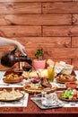 Georgian national cuisine. the girl pours red wine in a glass from an earthenware jug Royalty Free Stock Photo