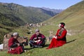 Georgian people in their traditional, local dresses have a nice time all together in the Caucasus Mountains.