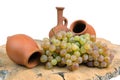 Georgian traditional decorative clay jugs for wine with grape on the wooden log slice Royalty Free Stock Photo