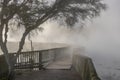 Mysterious walkway through steaming thermal lake, Rotorua, New Zealand Royalty Free Stock Photo
