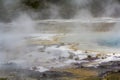 Geothermal activity, Rainbow Terrace with blue hot pool and steam Royalty Free Stock Photo