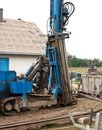 Geothermal drilling for house Heavy machine with drills next to newly constructed private house Royalty Free Stock Photo