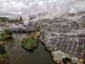 Geothermal field with geyser on a cloudy day in New Zealand Royalty Free Stock Photo