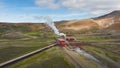 Geothermal power station in Icelandic landscape, steaming chimneys in a valley Royalty Free Stock Photo
