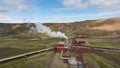 Geothermal power station in Icelandic landscape, steaming chimneys in a valley Royalty Free Stock Photo