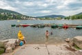 muslim family enjoys swimming in the gerldmer lake with boats and beautiful landscape in background