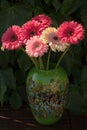 Gerbera daisies in green vase made from mozaic murano glass