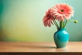Gerbera in a vase on a wooden table. Pastel background. Copy space on pastel background.