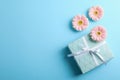 Gerberas with present on color  background Royalty Free Stock Photo