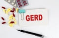 GERD text written in a card with pills. Medical concept