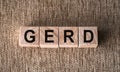 GERD word written on wooden blocks on a brown background