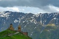 Gergeti Holy Trinity Church and Kazbegi mountain from Stepancminda village in Georgia Royalty Free Stock Photo