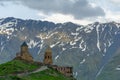 Gergeti Holy Trinity Church and Kazbegi mountain from Stepancminda village in Georgia Royalty Free Stock Photo