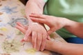 Geriatric nurse anoints elderly womans hand Royalty Free Stock Photo