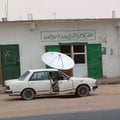 Car parked in front of a satellite antennas shop