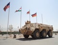 German armored ambulance vehicle fuchs in front of national flags