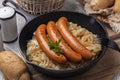 German or Austrian dinner. Wurstel sausage or frankfurter and fried crauti Royalty Free Stock Photo