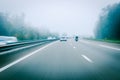 German autobahn highway blurred motion with white car and motorcyclist Royalty Free Stock Photo