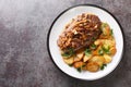 German beef steak Rostbraten with onion and fried potatoes closeup on the plate. Horizontal top view Royalty Free Stock Photo