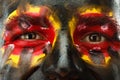 Eyes of German or Belgian sports fan patriot. Painted country flag on man face. Royalty Free Stock Photo
