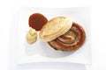 German Bratwurst, fried sausage and bread roll on plate Royalty Free Stock Photo