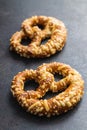 German bread pretzel with baked cheese on kitchen table