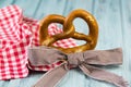 German bretzel and checkered bow on wooden background Royalty Free Stock Photo