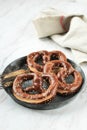 German Brezel Pretzel with Sesame Seed on Rustic Plate Royalty Free Stock Photo