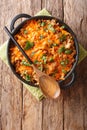 German cabbage casserole with ground beef, tomatoes, onions and cheddar cheese close-up in a pan. Vertical top view Royalty Free Stock Photo