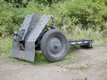 German cannon during the second world war on a cloudy summer day painted in black camouflage.